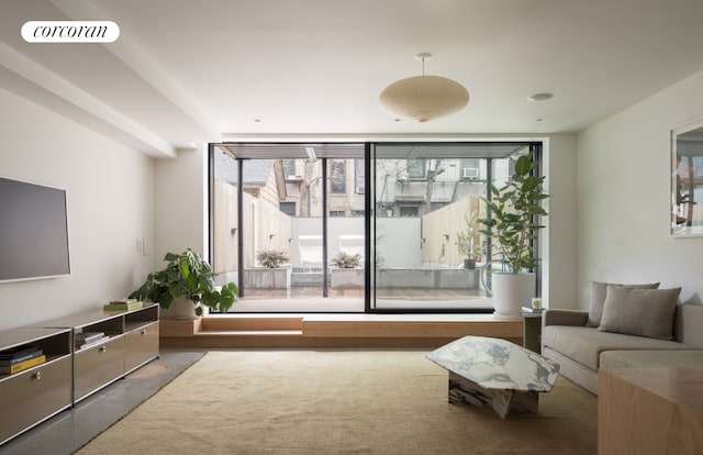 living room featuring a wall of windows and visible vents