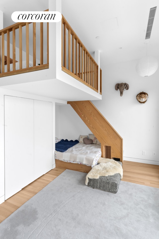 bedroom featuring visible vents, wood finished floors, and a closet