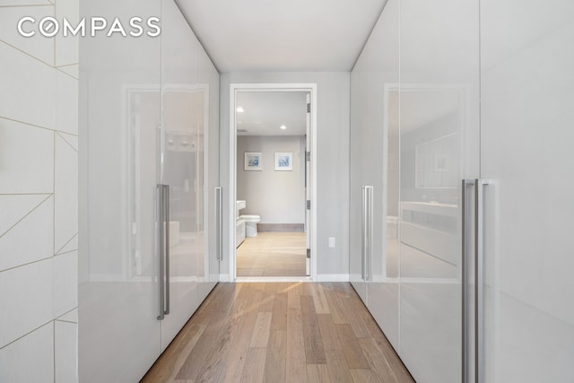 bathroom featuring recessed lighting, baseboards, and wood finished floors