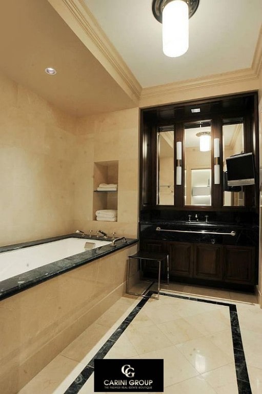 55 Wall St Unit 632, New York City, NY 10005 - full bathroom featuring a bath, inlaid floor details, and vanity