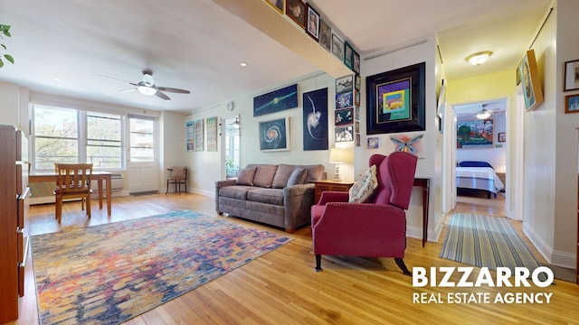 living area featuring a ceiling fan and wood finished floors