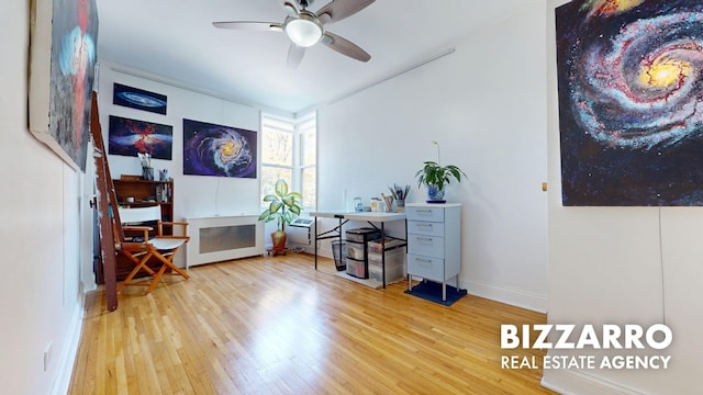 office space with baseboards, ceiling fan, and wood finished floors