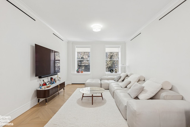 living area with baseboards and crown molding