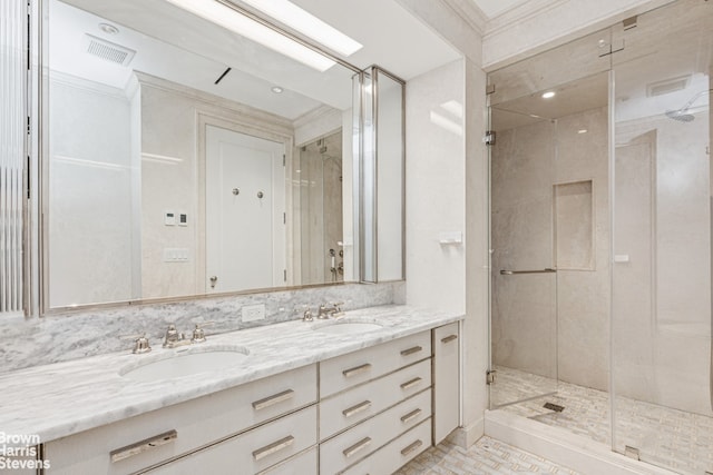 full bath featuring a shower stall and double vanity