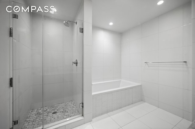 full bathroom with a garden tub, recessed lighting, and a shower stall