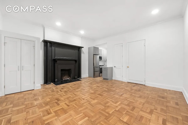 134 W 80th St Unit 2R, New York City, NY 10024 - unfurnished living room with baseboards, a fireplace with flush hearth, and recessed lighting