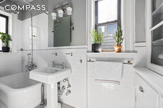 full bath featuring a wealth of natural light and tile walls