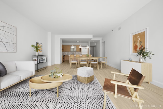 121 W 19th St Unit 9E, New York City, NY 10011 - living area featuring light wood finished floors and baseboards