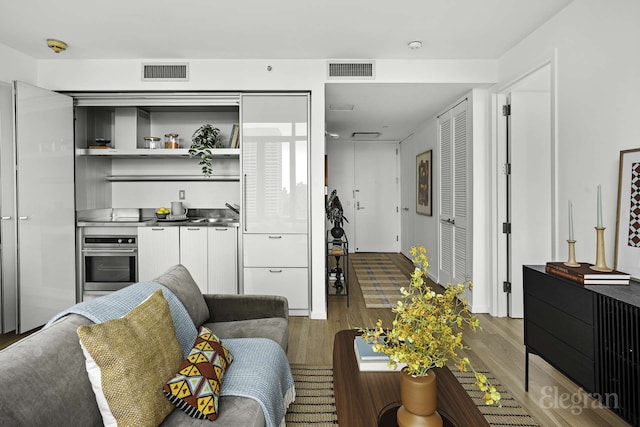 18 W 48th St Phd, Phd, New York City, NY 10036 - living room featuring visible vents and wood finished floors