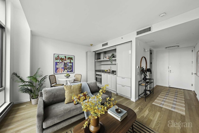 18 W 48th St Phd, Phd, New York City, NY 10036 - living area with visible vents and light wood-style floors