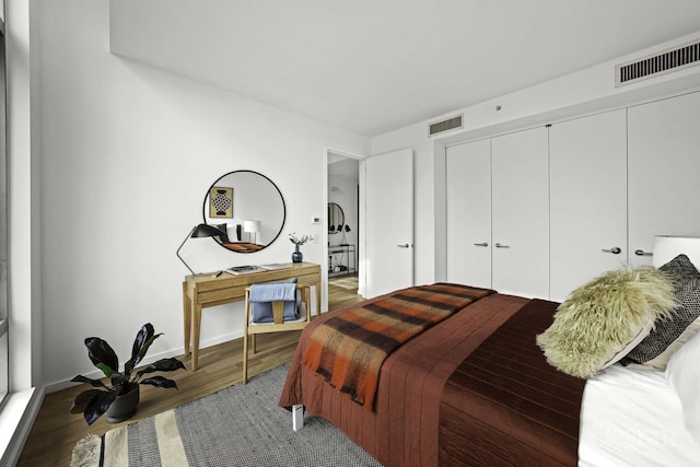 18 W 48th St Phd, Phd, New York City, NY 10036 - bedroom with baseboards, visible vents, wood finished floors, and a closet
