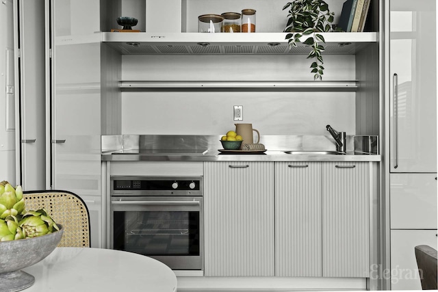 18 W 48th St Phd, Phd, New York City, NY 10036 - kitchen featuring stainless steel counters, open shelves, and oven