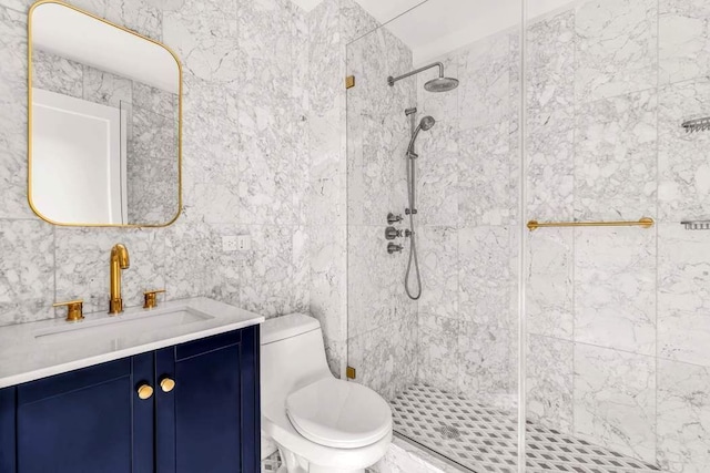 full bathroom with vanity, toilet, tile walls, and a stall shower