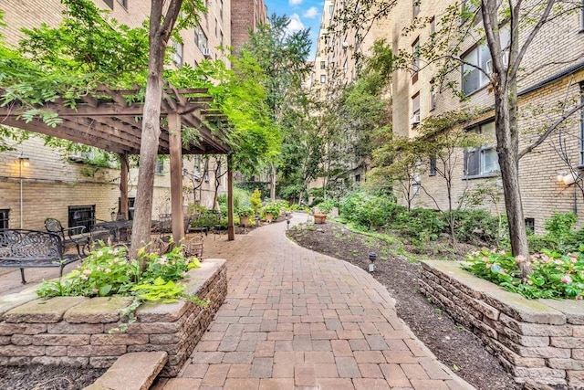 view of property's community with a patio and a pergola