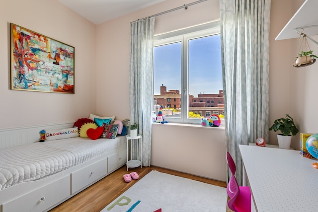 bedroom featuring multiple windows and light wood-style flooring
