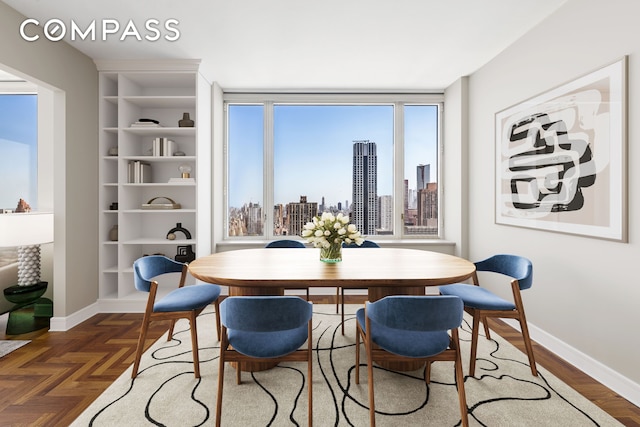 dining room with baseboards and a view of city