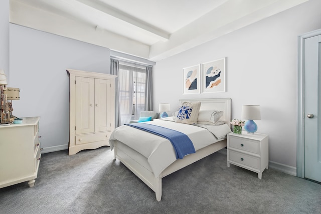 carpeted bedroom with baseboards and beam ceiling