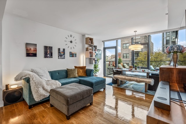 living area with light wood finished floors and expansive windows