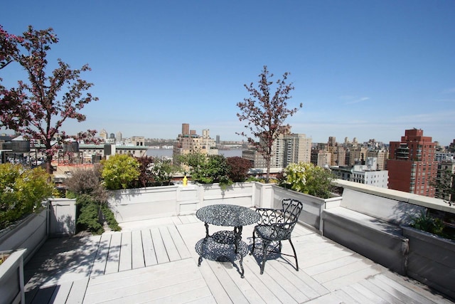 wooden deck with a city view