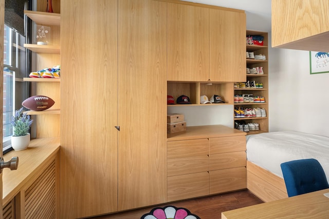 bedroom with dark wood finished floors