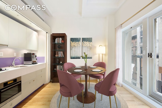 dining space featuring light wood-style floors and plenty of natural light