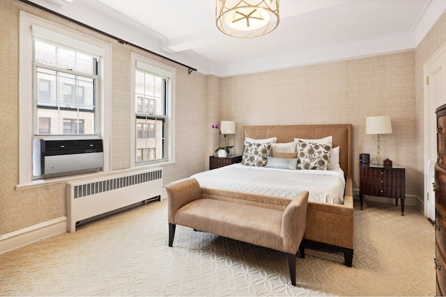 bedroom featuring radiator and a chandelier