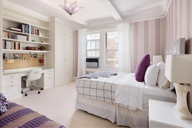 bedroom with beamed ceiling, light carpet, and a closet