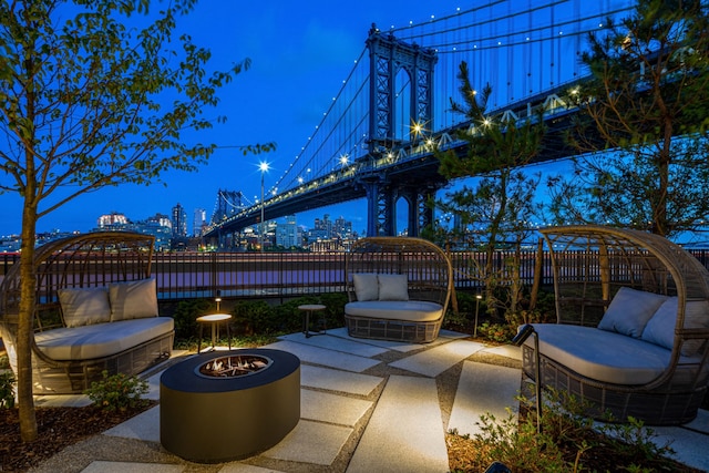 view of patio featuring fence and a city view