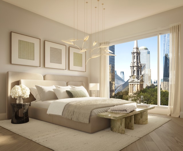 bedroom with a city view and wood finished floors