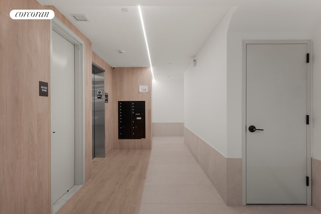hallway with visible vents and elevator