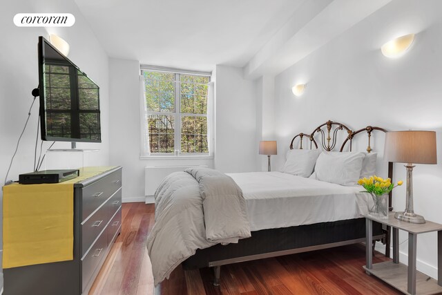 313 W 119th St Unit 4F, New York City, NY 10026 - bedroom featuring wood finished floors and baseboards