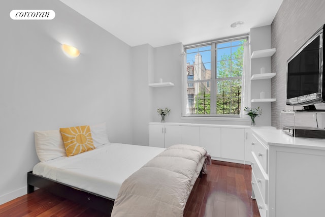 bedroom featuring visible vents and dark wood-style floors