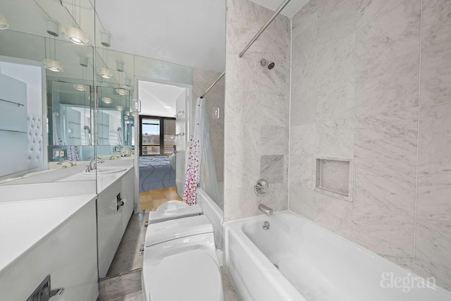 bathroom with vanity, shower / bath combo, and toilet
