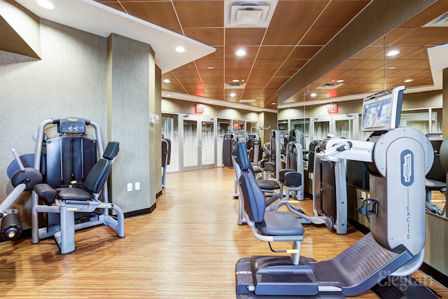 exercise room featuring recessed lighting, baseboards, visible vents, and wood finished floors