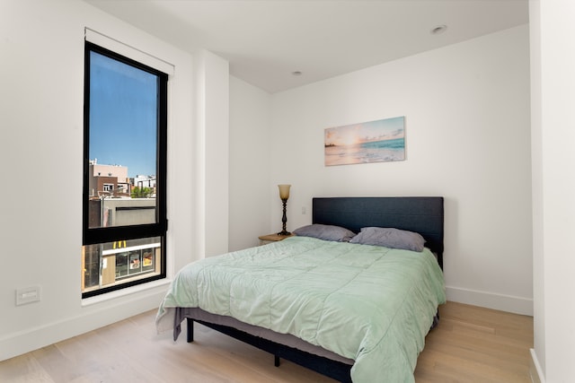 bedroom with wood finished floors and baseboards