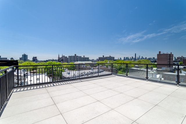 view of patio featuring a skyline view and a balcony