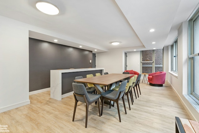 dining room with recessed lighting, baseboards, and light wood-type flooring