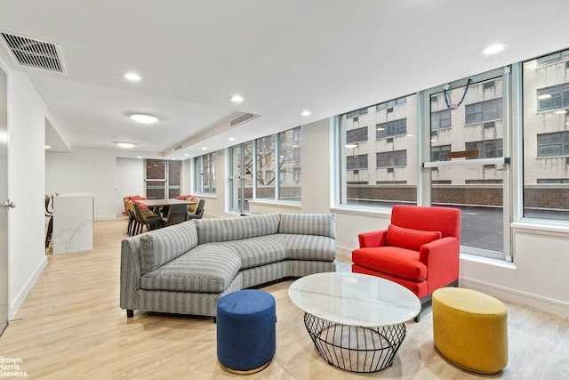 living area featuring recessed lighting, baseboards, visible vents, and wood finished floors