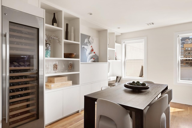 141 W 126th St Unit 4A, New York City, NY 10027 - dining area with wine cooler and light wood-style floors