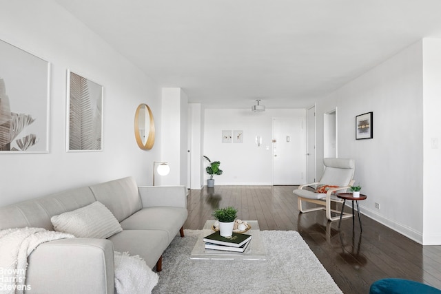 living room with baseboards and dark wood-style flooring