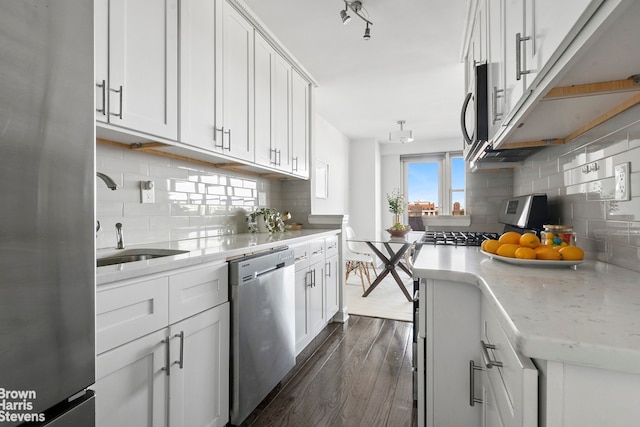 kitchen featuring dark wood finished floors, appliances with stainless steel finishes, backsplash, and white cabinets