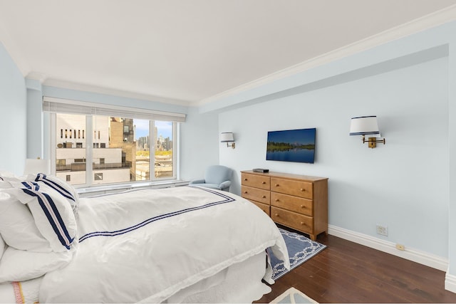 bedroom featuring crown molding, baseboards, and hardwood / wood-style floors