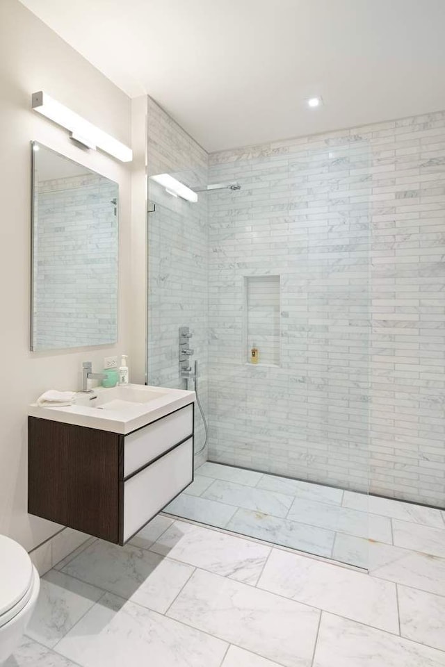 16 E 80th St Unit 4B5Bc, New York City, NY 10075 - bathroom with marble finish flooring, a walk in shower, toilet, vanity, and recessed lighting