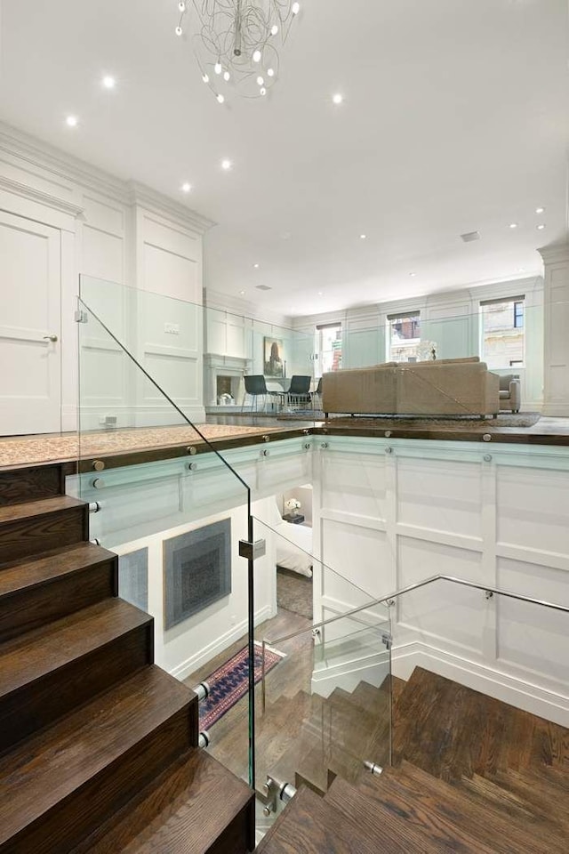 16 E 80th St Unit 4B5Bc, New York City, NY 10075 - stairs with wood finished floors, recessed lighting, and a chandelier