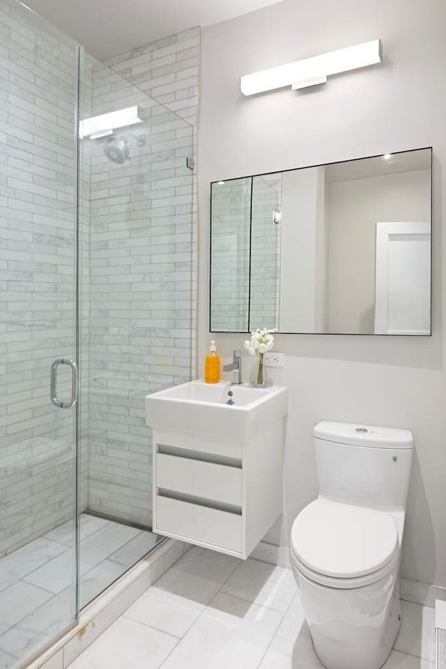 16 E 80th St Unit 4B5Bc, New York City, NY 10075 - bathroom with a shower stall, toilet, vanity, and tile patterned flooring