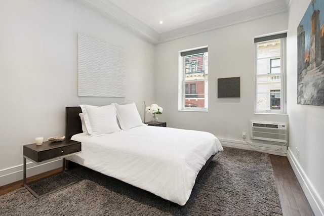 16 E 80th St Unit 4B5Bc, New York City, NY 10075 - bedroom with wood finished floors, crown molding, an AC wall unit, and baseboards
