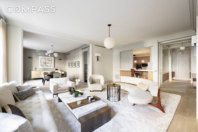 565 Park Ave Unit 2, New York City, NY 10065 - living room with wood finished floors, ornamental molding, and a chandelier