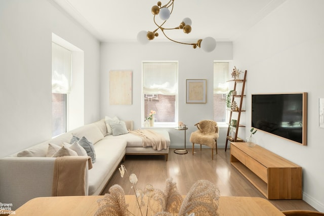 350 W 71st St Unit 2F, New York City, NY 10023 - living area with baseboards, a notable chandelier, ornamental molding, and wood finished floors