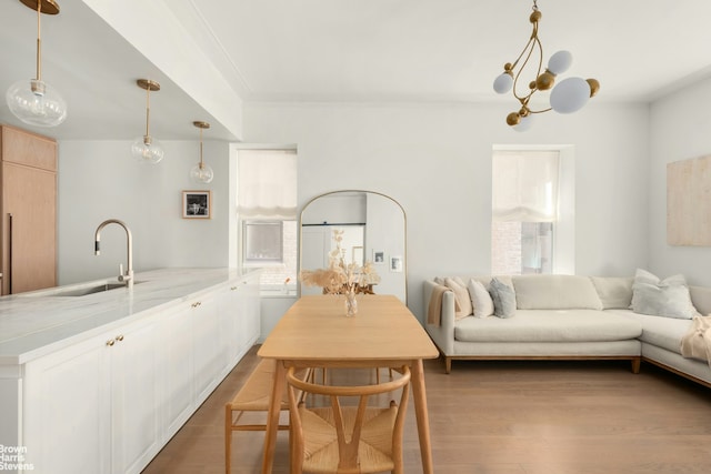 350 W 71st St Unit 2F, New York City, NY 10023 - dining space featuring plenty of natural light, ornamental molding, dark wood finished floors, and a notable chandelier
