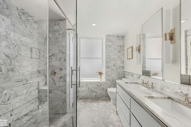 350 W 71st St Unit 2F, New York City, NY 10023 - full bathroom with a sink, tile walls, a shower stall, and toilet